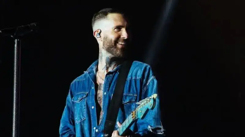 Maroon 5’s Adam Levine invites an emotional fan on the stage during the concert in India