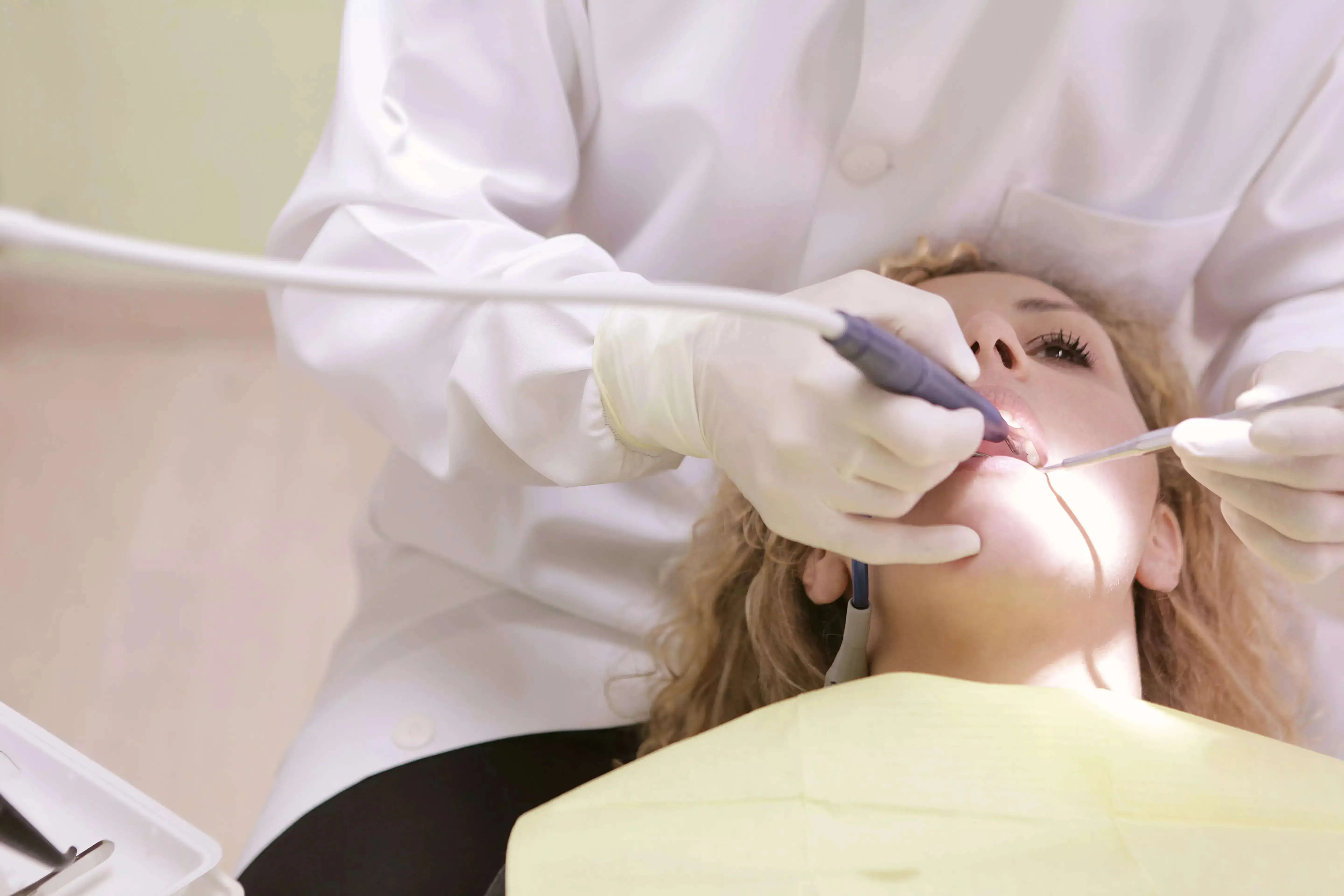 A doctor examining the teeth of a patient