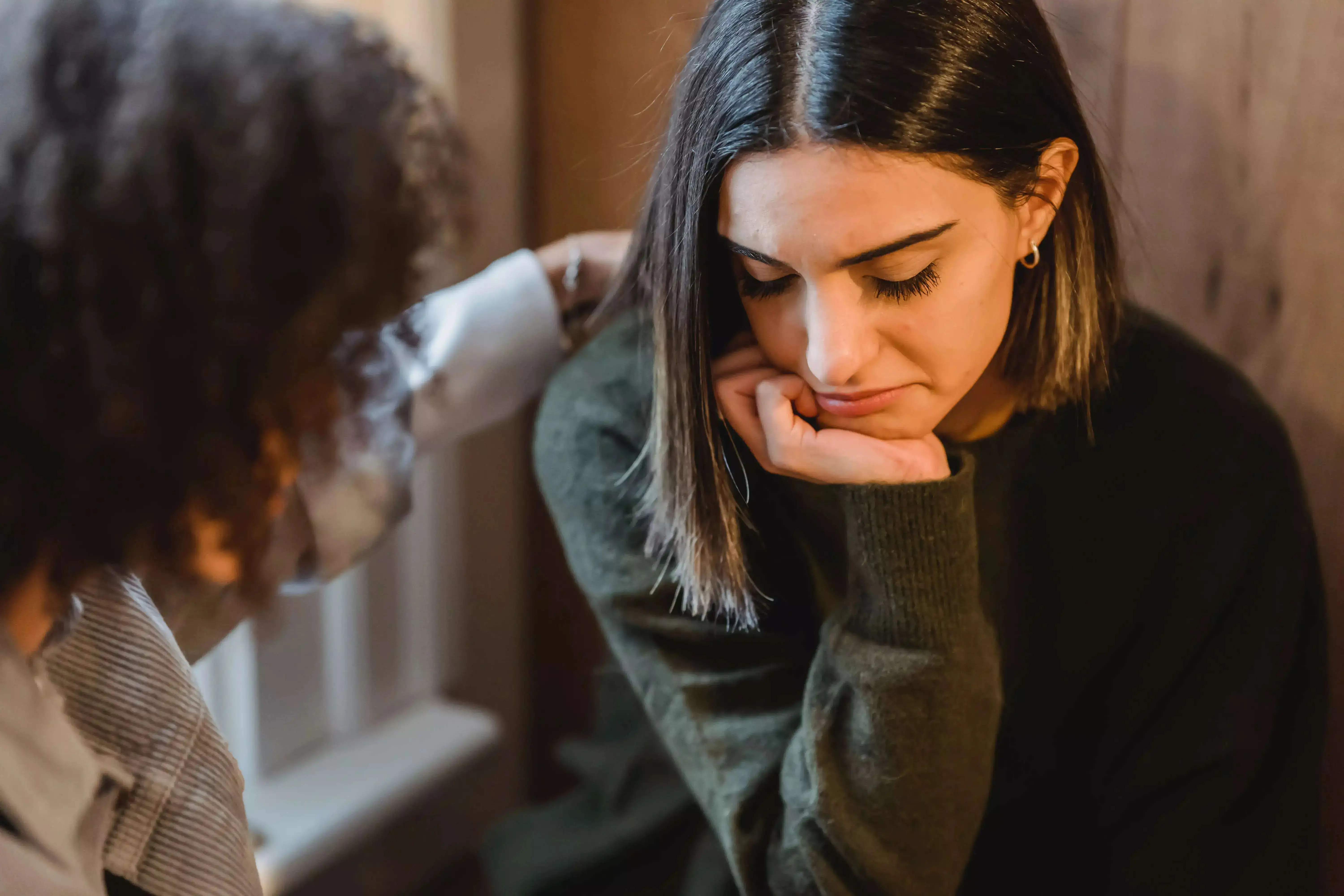 A woman offering emotional support to a girl