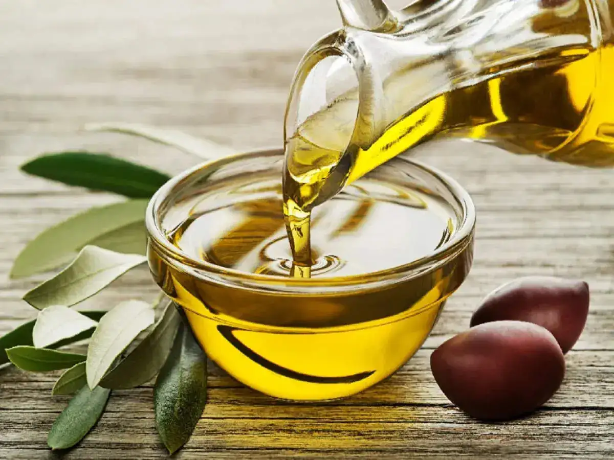 Olive oil being poured in a small bowl