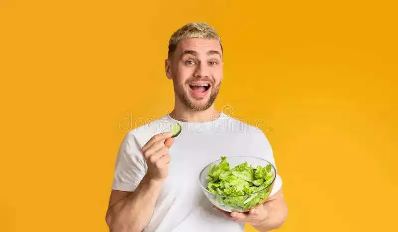 man-diet-fun-studio-happy-guy-eat-vegetables-panorama-free-space-176770762