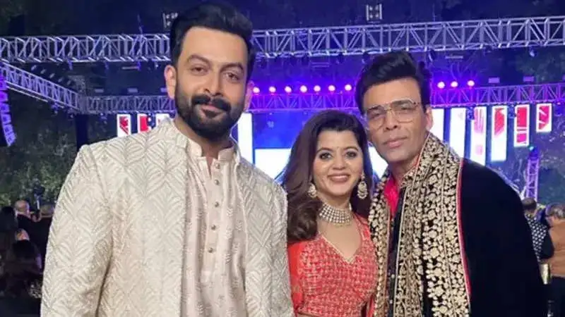 Prithviraj Sukumaran and wife Supriya pose with Karan Johar at Sidharth-Kiara wedding